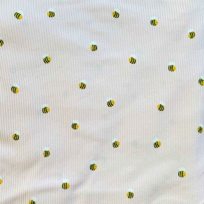 Pattern of small bees on a textured beige background