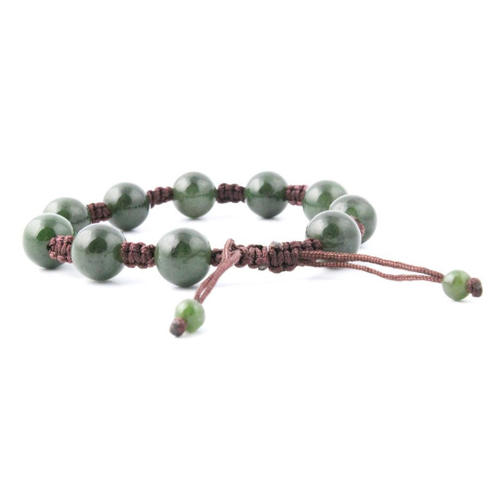 Green jade bead bracelet on a brown adjustable cord with knotted sections.
