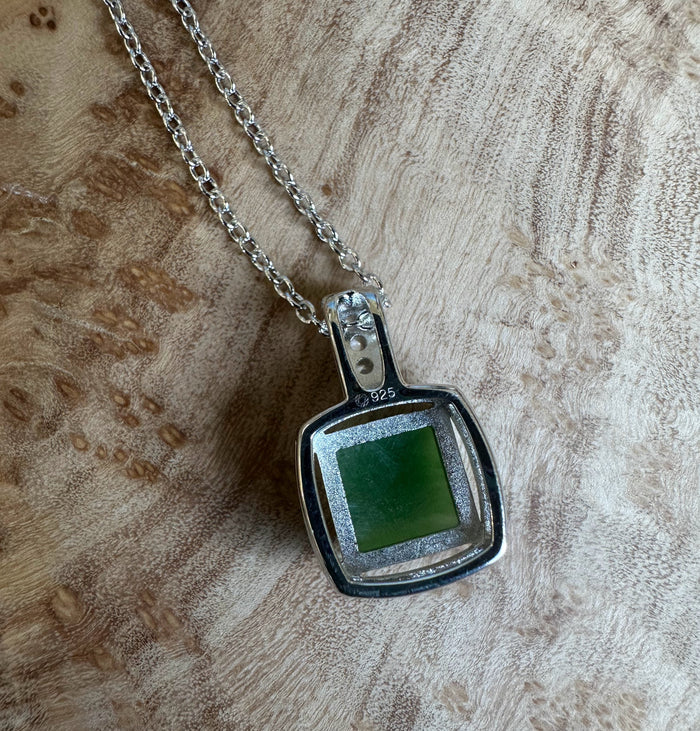 Canadian Jade Pendant with CZ 5560 featuring a square green jade centerpiece in a silver frame on a chain