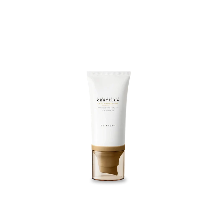 Skincare product with white container and gold base on a white background