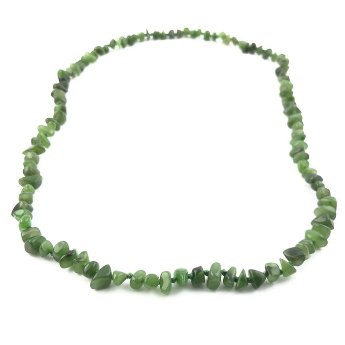 Green jade chip bead necklace arranged in a loose circular loop.