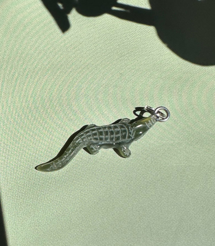 Dark green jade alligator pendant with metal loop at its head