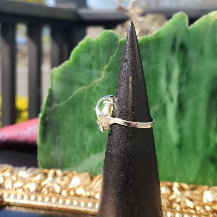 Silver Jade Ring in side view on a black cone display with the green jade cabochon visible.