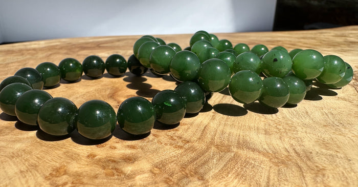 Green beaded bracelet on a wooden surface