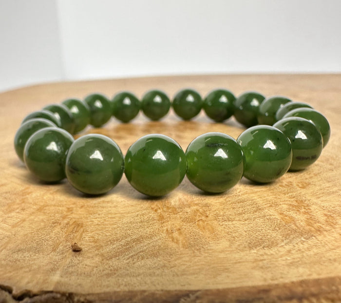 Green beaded bracelet on a wooden surface