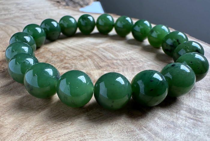 Green beaded bracelet on a wooden surface