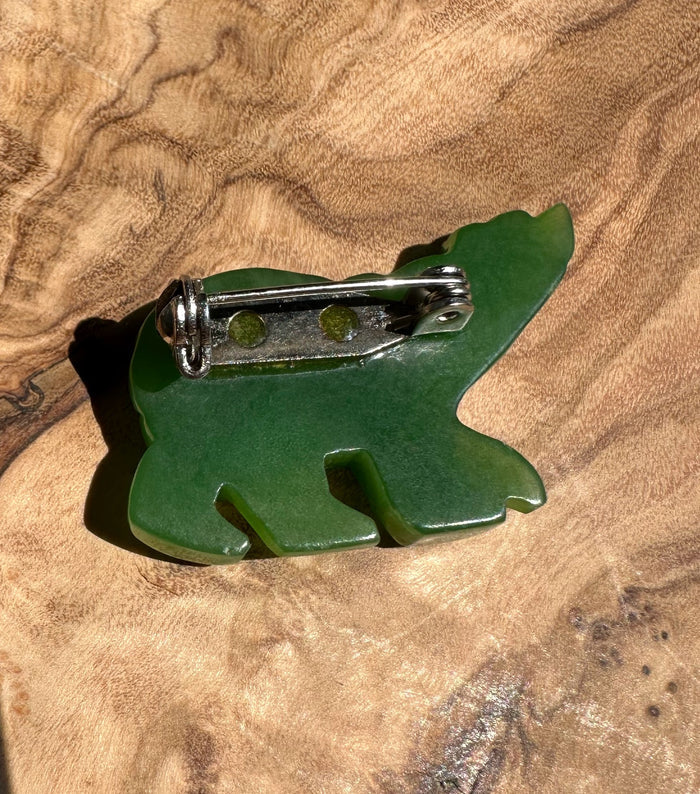 Back view of the green jade bear brooch showing the pin mechanism.