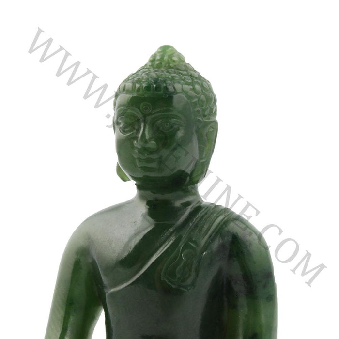Close up of green jade Buddha bust with draped robe against white background.