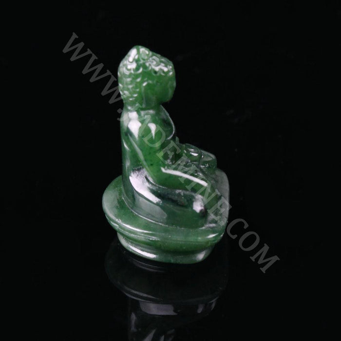 Green jade Buddha statue seated in meditation on a circular pedestal, side profile