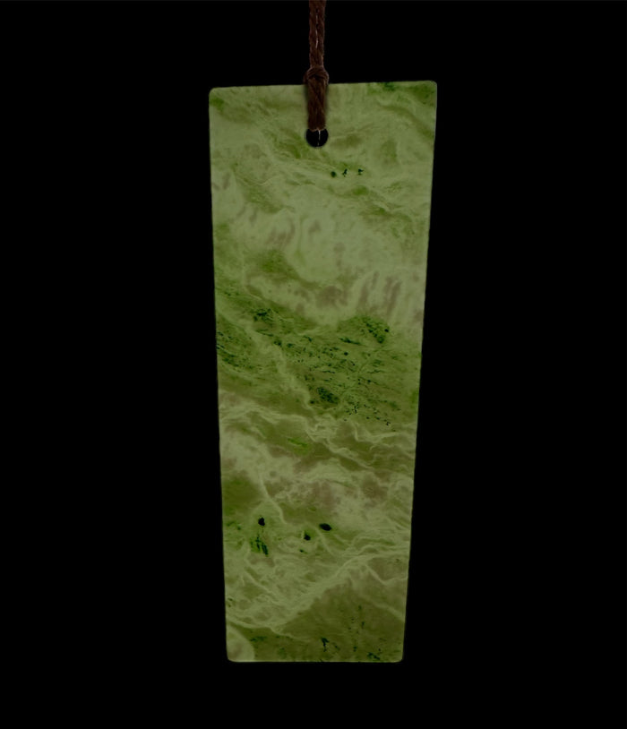 Six inch Canadian Jade bookmark with a pale green marbled pattern and a brown cord through the top hole.
