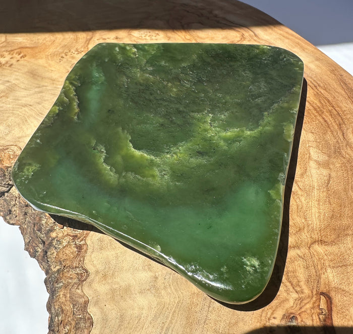 Green jade dish on a wooden surface