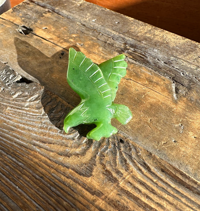 Canadian jade eagle brooch carved in green with wings spread.