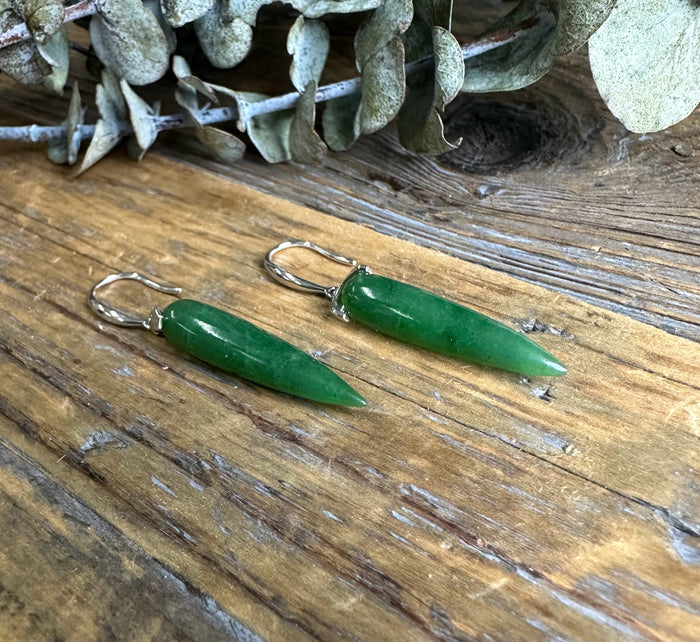 Canadian Jade Earrings JN3 green jade drop earrings with silver hooks on rustic wooden surface