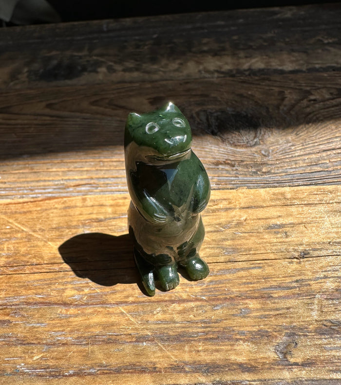 Canadian Jade Otter figurine viewed from front-right standing on sunlit wood
