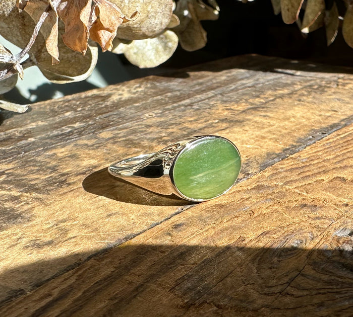 Canadian Jade Ring with round green jade cabochon set in a polished silver bezel and a decorative silver band