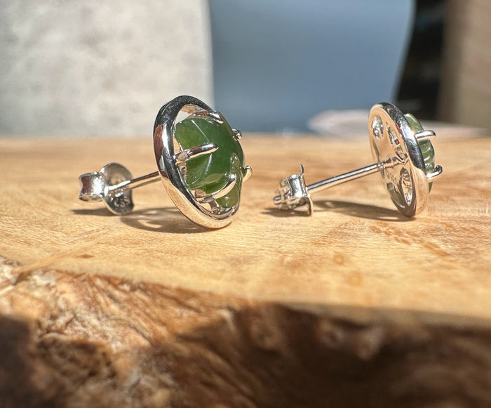 Side view of circular silver jade star studs with posts and backs