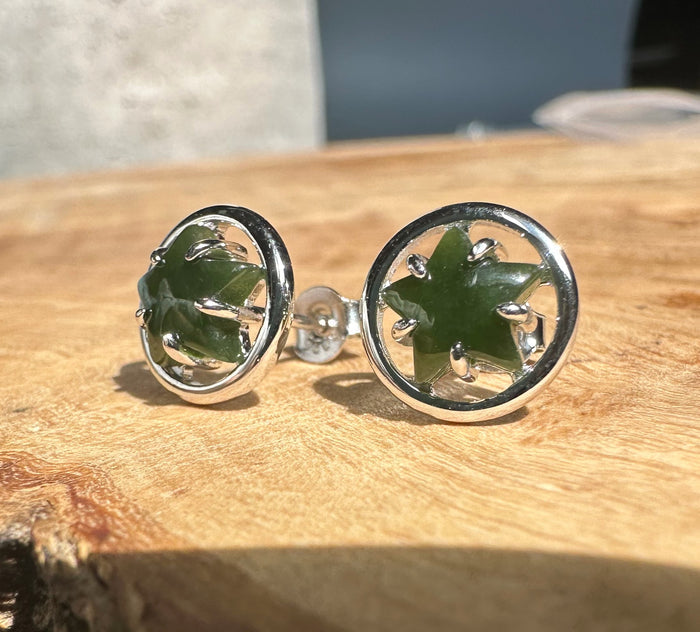 Green jade star studs set in silver circular bezels with prong accents