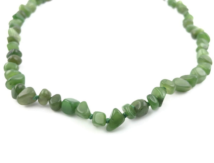 Close-up of a green chip bead necklace with irregular translucent beads
