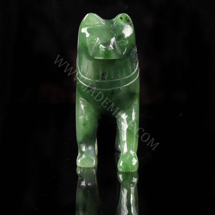 Front view of green jade husky statue standing on a black surface.