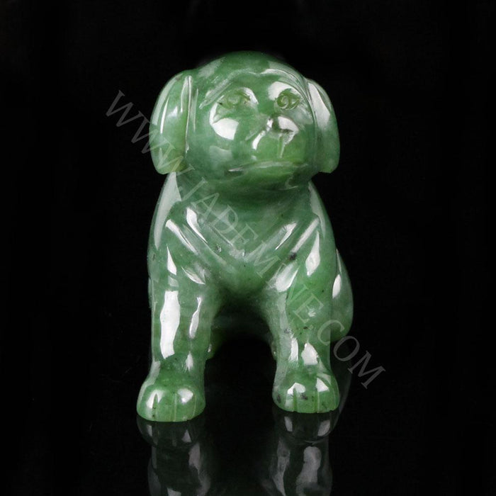 Glossy green Labrador figurine facing forward against a black background.