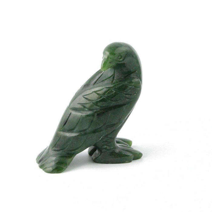 Green jade eagle sculpture standing on a base.