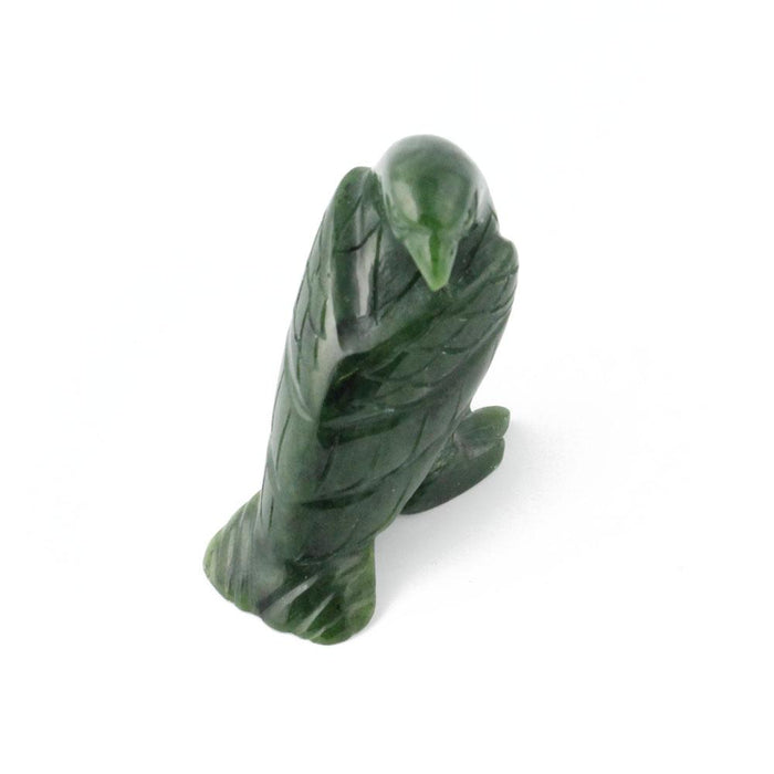 Green jade eagle figurine standing with wings folded along its body