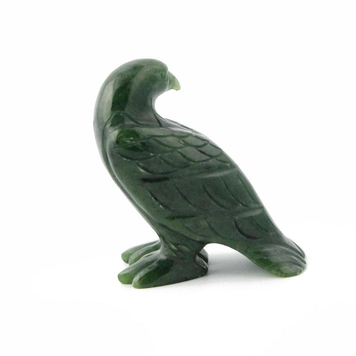 Green jade eagle figurine in profile with curved neck and feather details