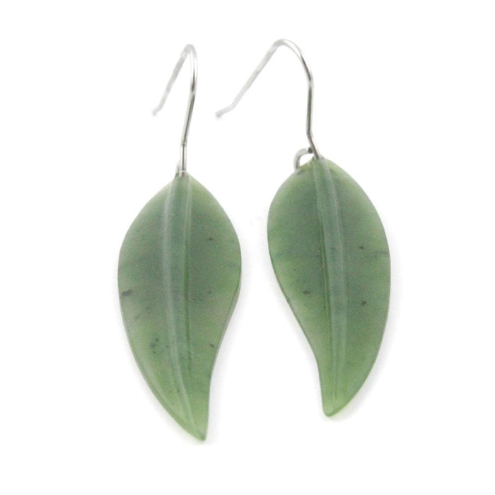 Pair of pale green leaf earrings with curved silver hooks on a white background