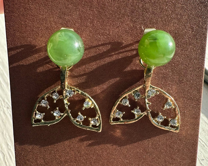 Whale tail earrings with bright green nephrite cabochons and crystal studded gold leaf tails