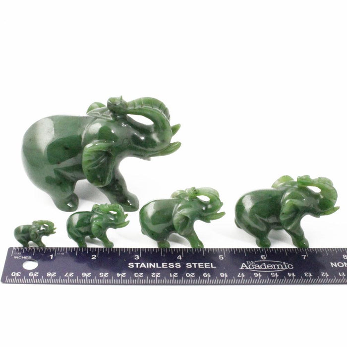 Assorted jade elephant along side a ruler for scale on size