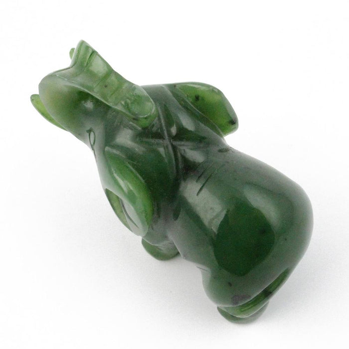Green jade elephant figurine with trunk raised, smooth polished sculpture.