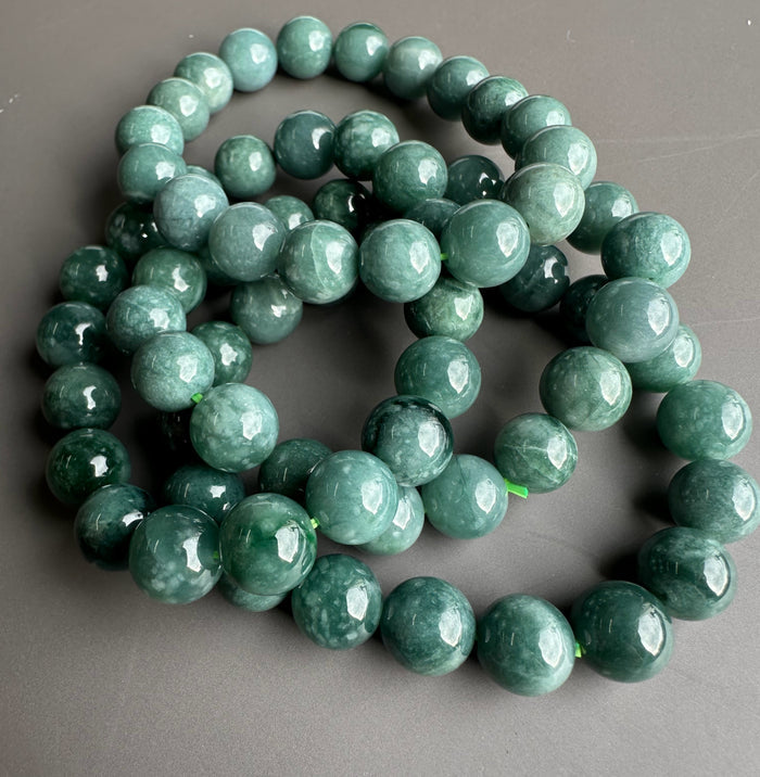 Guatemalan jadeite beads 10mm, glossy green spheres forming a bracelet