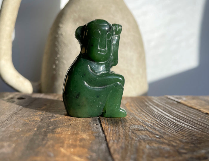 Dark green jade monkey figurine with a glossy finish.