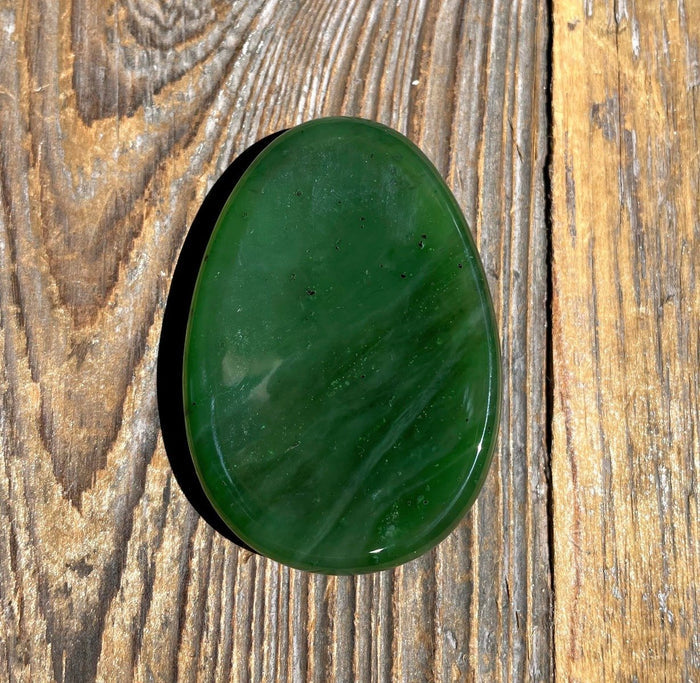 Green Jade Worry Stone on a wooden base
