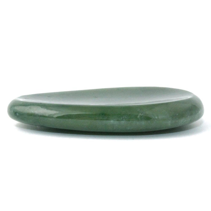 Green jade worry stone viewed from the side with a smooth glossy surface