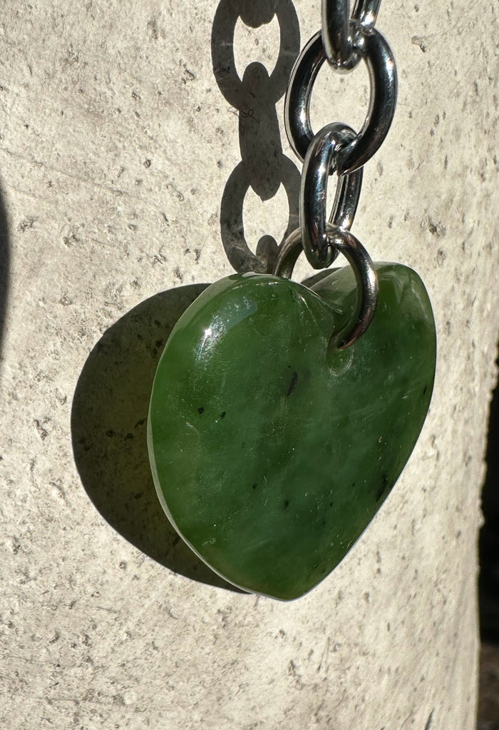 Green heart shaped stone keychain charm attached to a silver chain and rings