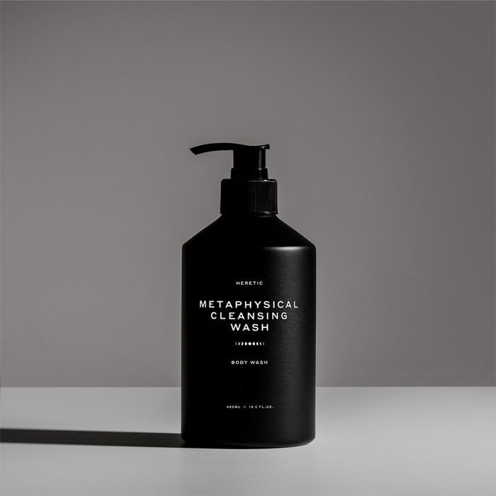 Black bottle of 'Metaphysical Cleansing Wash' on a gray background