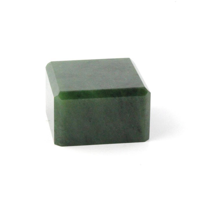 Dark green mineral specimen cut into a rectangular block with a beveled top edge.