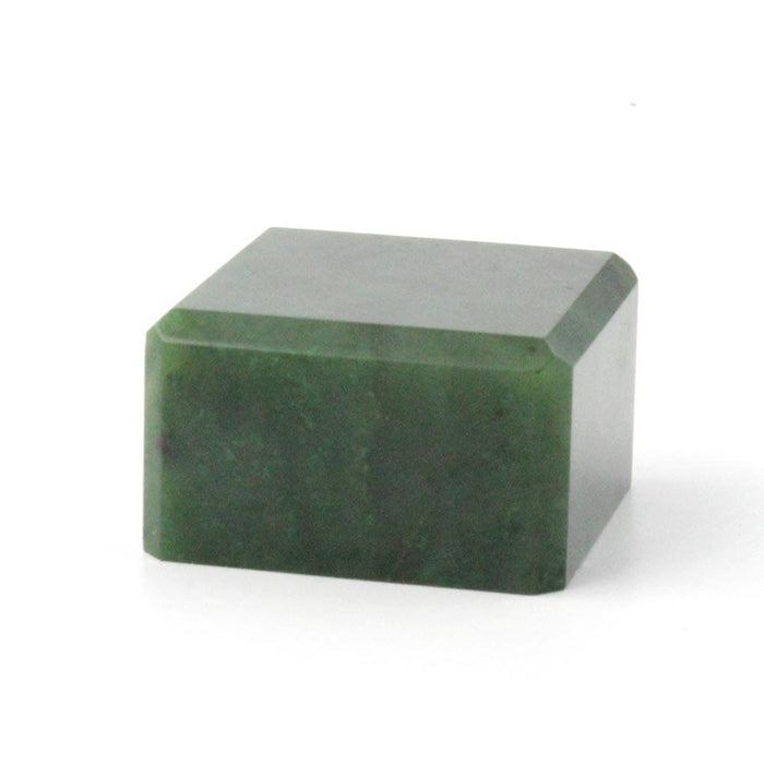 Deep green mineral specimen in a rectangular block with a diagonal top facet.