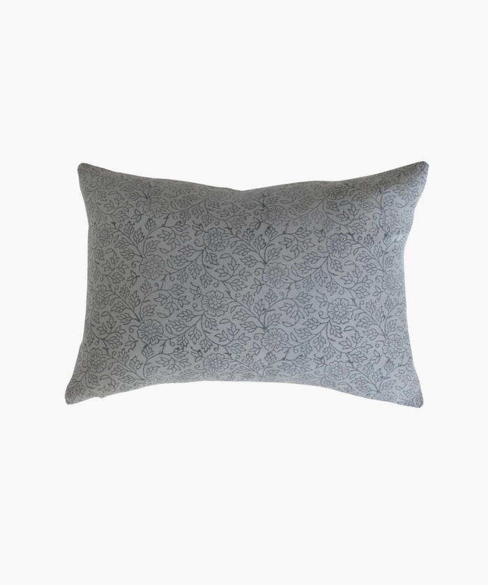 A rectangular lumbar pillow with a delicate gray floral pattern on a light background. The design features intertwined flowers and leaves, conveying a soft, elegant feel. | Wildwood Home Co.