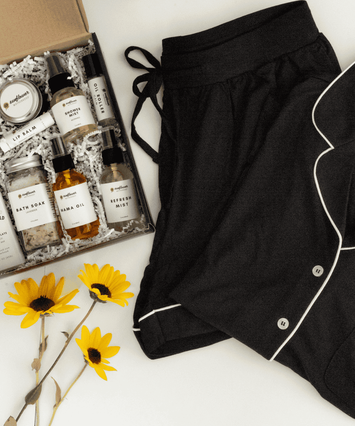 a lipbalm ang a bunch of bottles and a pair of black sleepwear