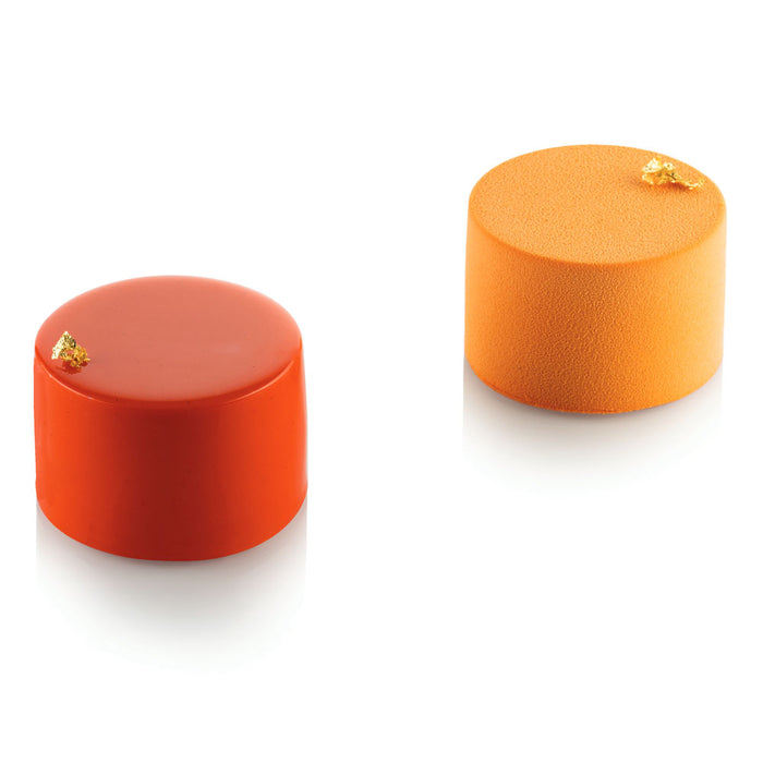 Two orange cylindrical pastries with gold accents on a white background