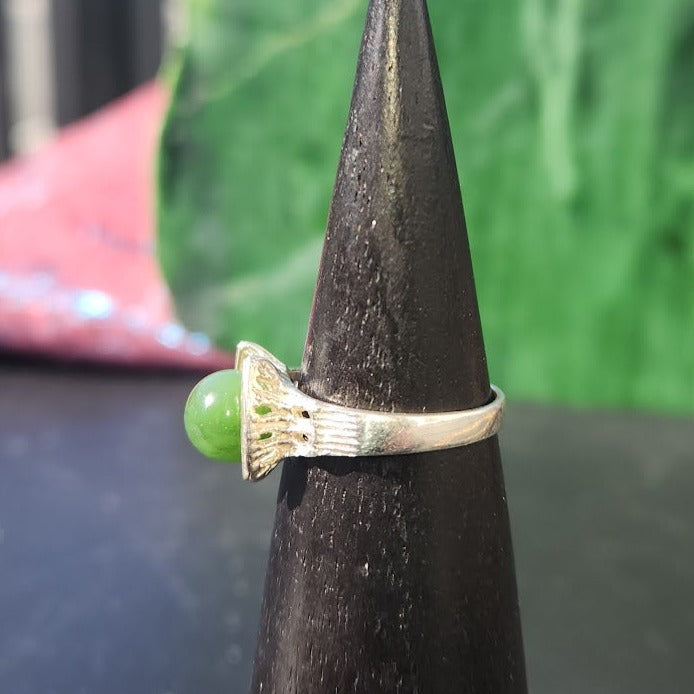 Silver Canadian Jade Star Ship ring with a round green jade centerpiece.