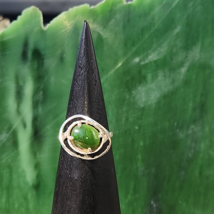 Silver Jade Ring #243S featuring a round green jade stone framed by looping silver circles.