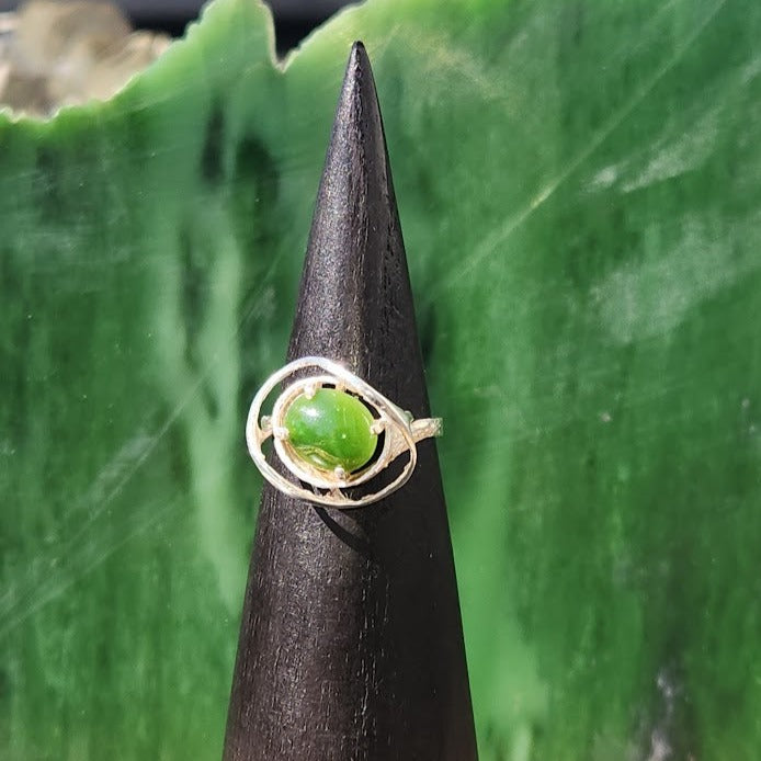 Close up of Silver Jade Ring #243S showing the green jade stone held by decorative circular silver bands.