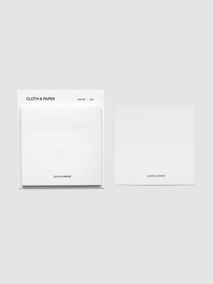 Sticky note set displayed against a neutral background. One note is placed on the packaging's edge. Color shown is Ash.