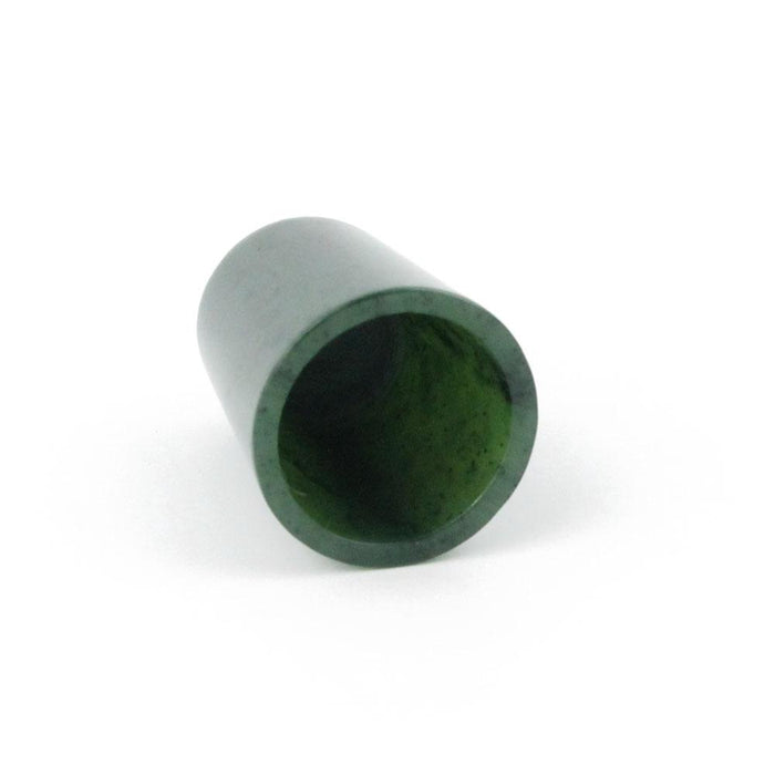 Green hollow thimble on its side showing the open end